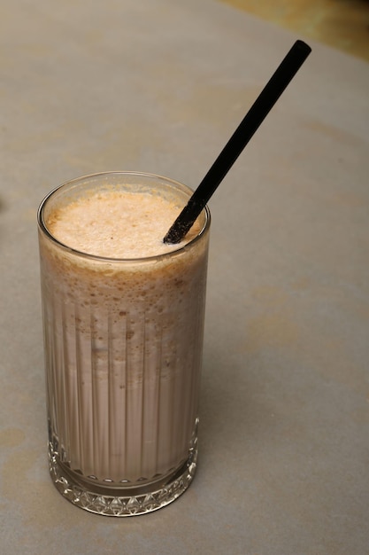 Café helado con leche. Café con leche helado. Mujer sosteniendo una taza de café helado.