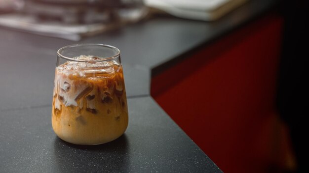 Café helado en una mesa con crema que se vierte mostrando la textura