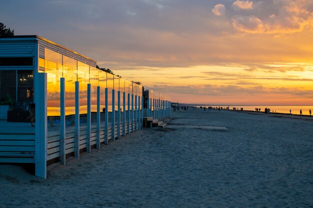 Café na praia durante o pôr do sol, lindas nuvens coloridas sobre o mar Báltico, no resort de Jurmala, Letônia relaxando