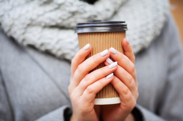 Café para viagem. jovem mulher com café no parque outono