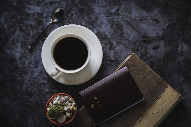 Café preto em uma xícara de café branca e cacto colocado