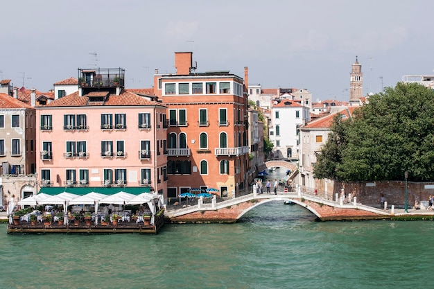 Cais e ponte sobre o canal perto do restaurante flutuante em Veneza