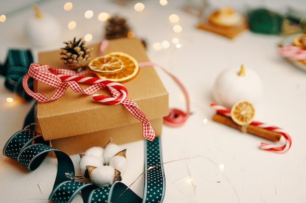 Caixa de presente de Natal e decorações em branco texturizado mesa doce cana fitas coloridas guirlandas drie ...
