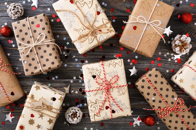 Caixas de presente de natal e decorações de brilho na mesa festiva.