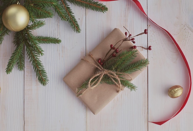 Caixas de presente de Natal e galho de árvore do abeto em mesa de madeira plana fundo de Natal