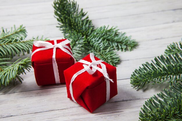 Caixas de presente de Natal e ramos de abeto em um fundo de madeira