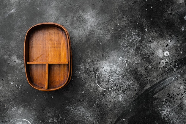 Caja de Bento vacía con espacio de copia para texto o comida con espacio de copia para texto o comida, vista superior plana, sobre fondo de mesa de piedra oscura negra