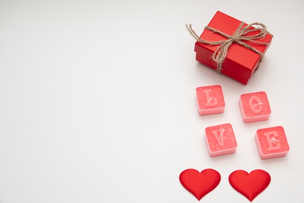 Caja y corazón rojo del día de San Valentín. Tarjeta de San Valentín de vacaciones con espacio de copia.