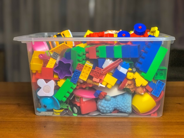 Caja con juguetes infantiles sobre la mesa durante los juegos.