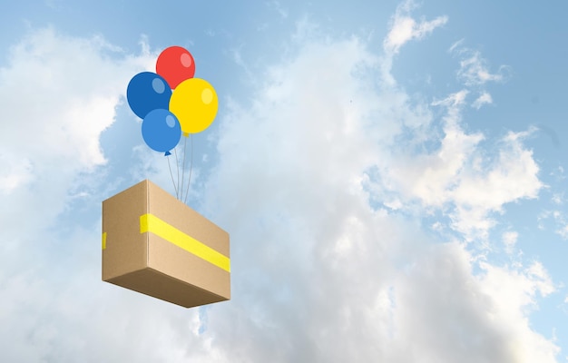 Caja de paquetes entregada por globos de colores en el cielo