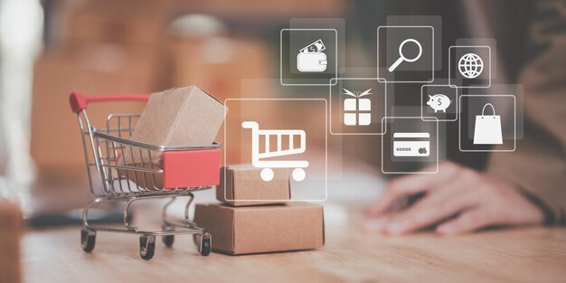 caja de producto del carrito de compras colocada en la mesa concepto de compras en línea web servi de compras
