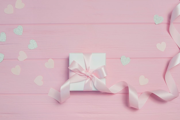 Caja de regalo con cinta y confeti en forma de corazón