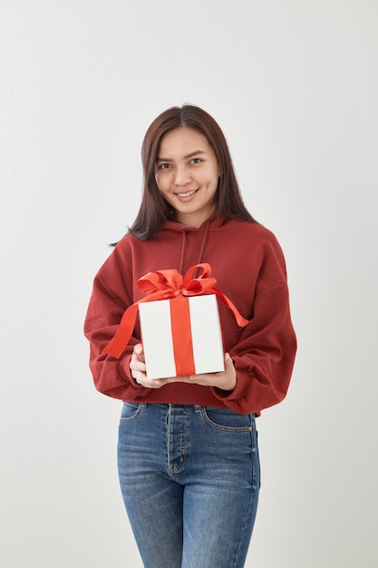 Caja de regalo feliz del control de la mujer joven en manos