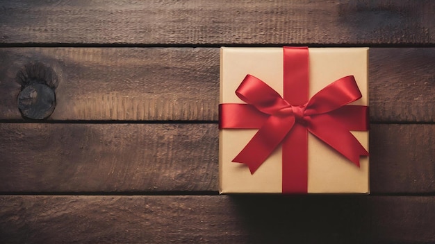 Caja de regalo con un lazo de cinta roja en fondo de madera