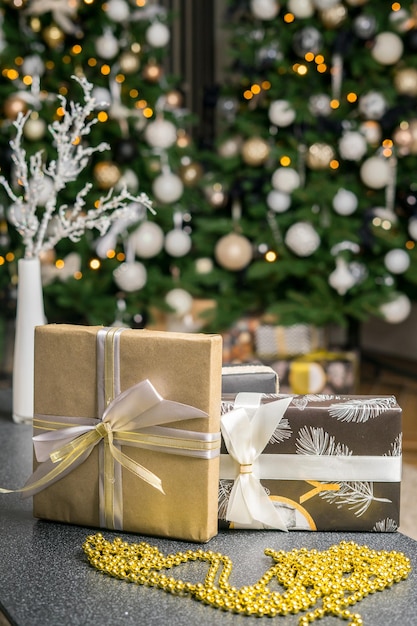 Caja de regalo de Navidad bajo el árbol de Navidad. Mañana de vacaciones. Paquete de papel presente de año nuevo. Actitud festiva. Foto de alta calidad