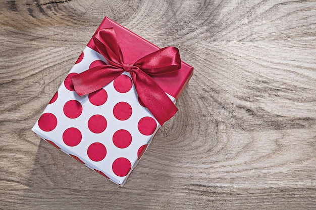 Caja de regalo roja en concepto de celebraciones de tablero de madera