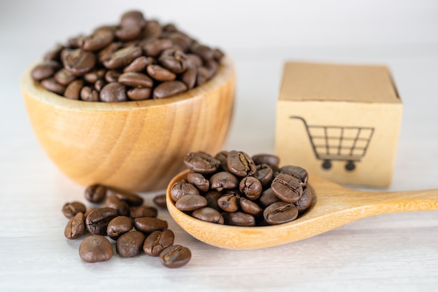 Caja con el símbolo del logotipo del carrito de compras en los granos de café Importación Exportación Compras en línea