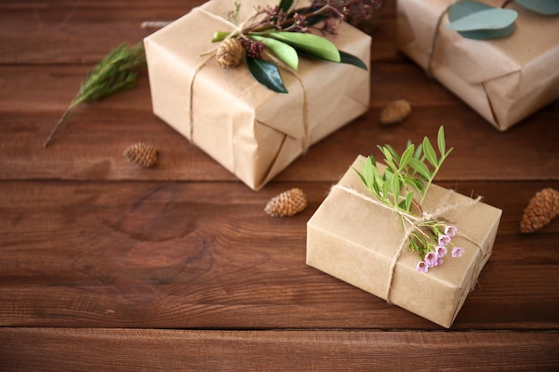 Cajas de regalo artesanales con flores en mesa de madera