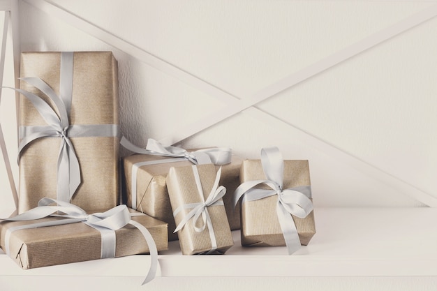 Cajas de regalo elegantes con cinta de raso envuelta en papel.