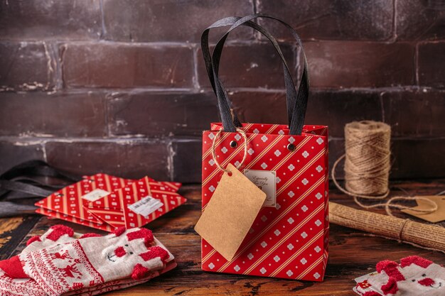 Cajas de regalo envueltas en papel rojo a cuadros y el contenido de un espacio de trabajo compuesto. Endecha plana.