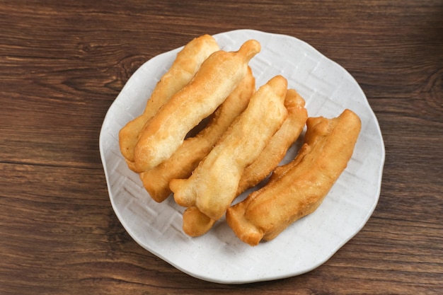 Cakwe o Cakue o Youtiao es un bocadillo tradicional chino tira larga de masa frita de color marrón dorado