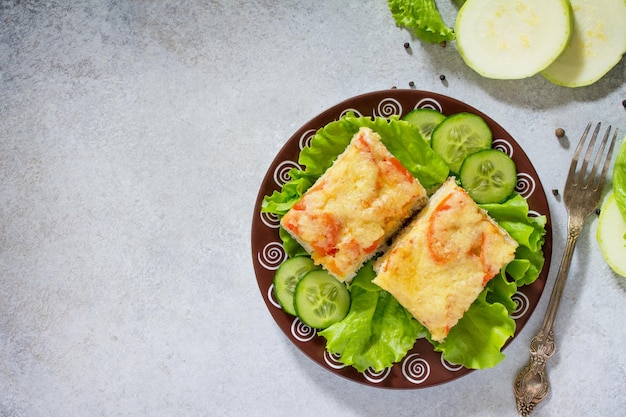 Calabacín al horno con tomates de arroz de carne y queso sobre un fondo de piedra gris o pizarra