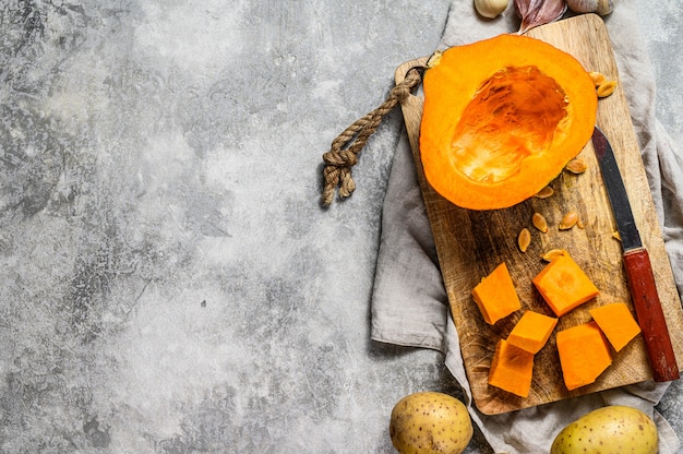 Calabaza picada en tabla de cortar rústica. Ingredientes para sopa de calabaza.