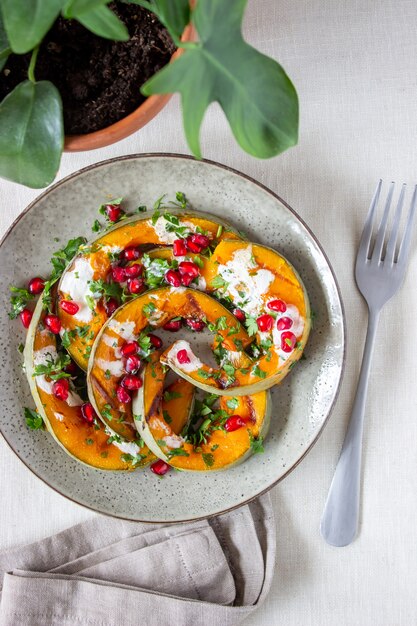 Calabaza a la plancha con granada y salsa blanca. Alimentación saludable.