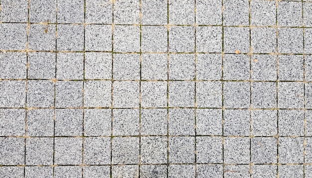 Foto calçada de pedra. pedras de pavimentação em estradas e calçadas da parte antiga da cidade. fundo de material de pedra de pavimentação. granito, paralelepípedo. modelo de piso de pavimentação de concreto para segundo plano.