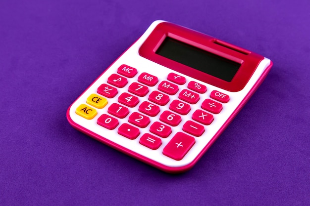 Calculadora de papelaria vermelho escola isolada em roxo