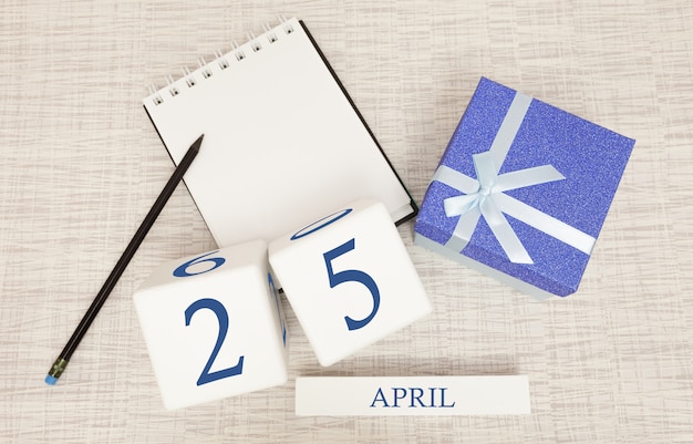 Calendário com texto azul na moda e números para 25 de abril e um presente em uma caixa.