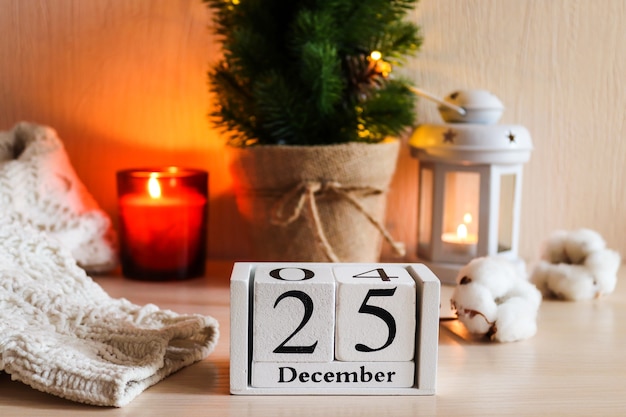 Calendario de madera con fecha de diciembre contra el enfoque selectivo de fondo festivo de Navidad