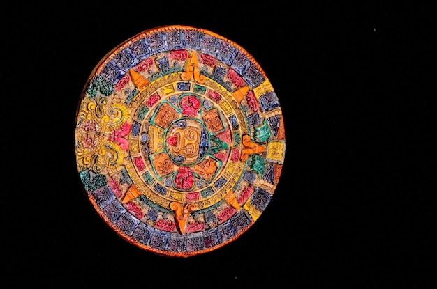 Calendario maya de arcilla coloreada típica aislada sobre fondo negro