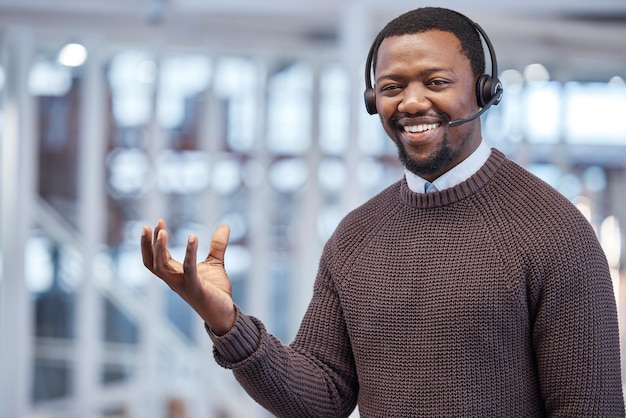 Call Center ou consultor de homem negro com a mão vazia, comercializando uma marca de produto e anunciando em um escritório Atendimento ao cliente de retrato e funcionário no espaço de maquete para marcar um logotipo na palma da mão