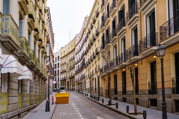 Calle angosta de Madrid con balcones típicos de la ciudad y edificios coloridos. España.