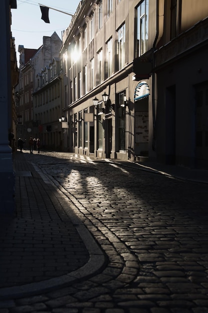 Las calles adoquinadas de la vieja ciudad europea por la mañana. Reflexiones sobre el pavimento. Riga.