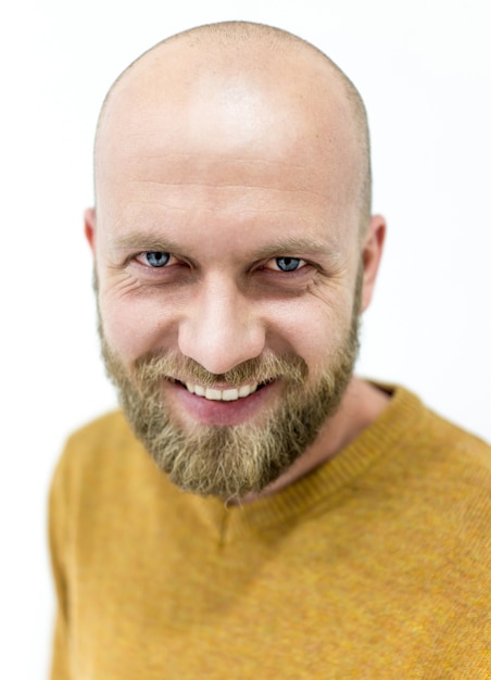 Foto calvo joven guapo con barba rubia sonriendo