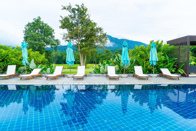 Cama de piscina alrededor de la piscina con fondo de colina de montaña