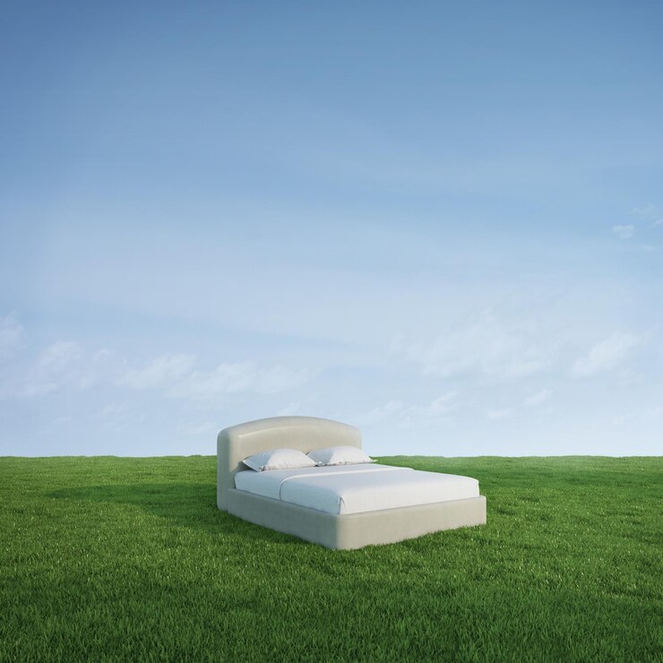 Cama sobre hierba de pradera verde con fondo de cielo azul
