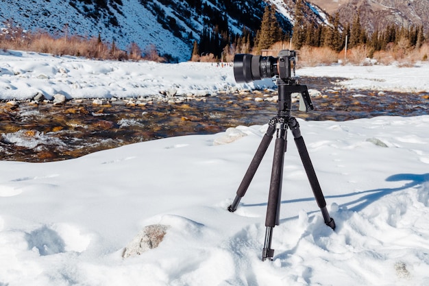 Foto cámara digital en trípode tomando fotos del río de montaña