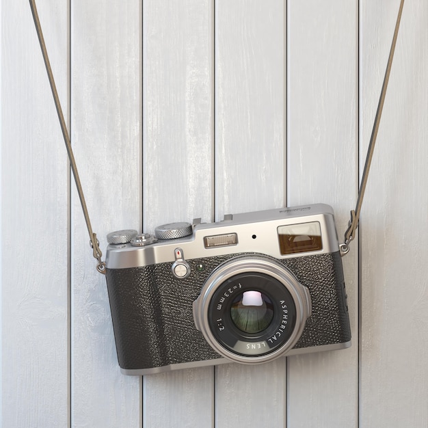 Una cámara fotográfica retro vieja colgada en la pared de madera blanca.