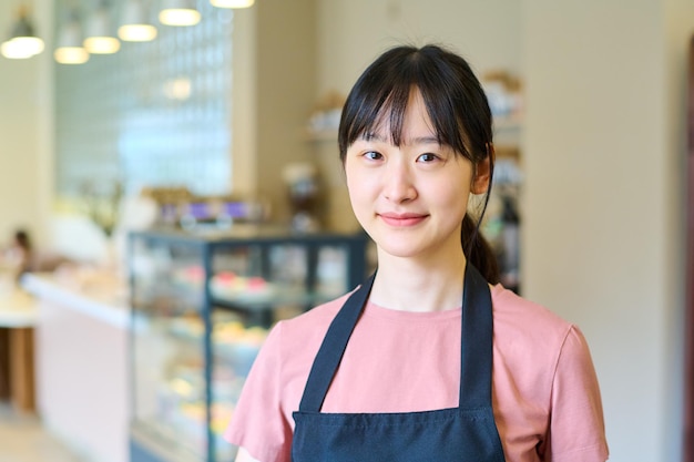 Camarera asiática sonriente en café