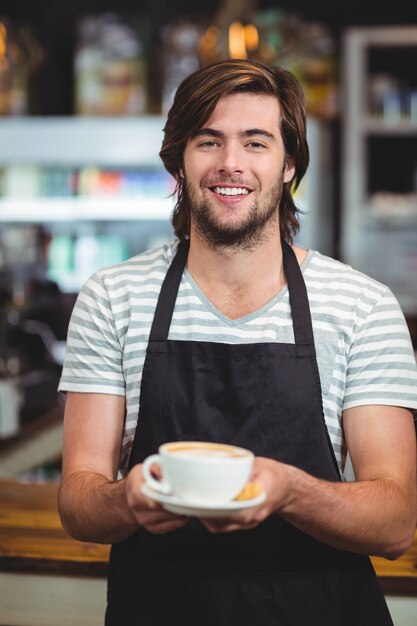 camarero ofreciendo una taza de café