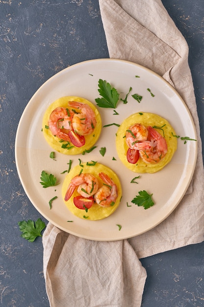 Camarones y polenta - fodmap dash dieta plato sin gluten, vista superior de cerca, vertical