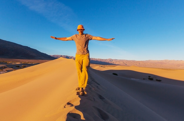 Caminante en el desierto de arena. Hora del amanecer.