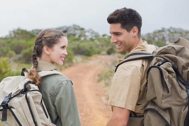 Caminhada casal andando no terreno da montanha