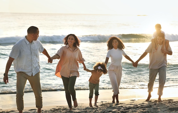 Caminhando feliz e grande família de mãos dadas na praia para confiança de férias e juntos em Bali Viagens pôr do sol e avós filhos e pais em uma caminhada à beira-mar para se relacionar e brincar