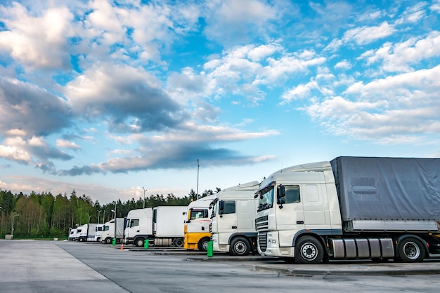 Caminhões seguidos com contêineres no estacionamento perto do conceito de logística e transporte florestal