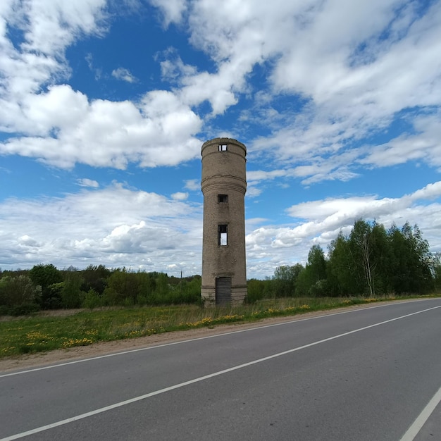 Un camino con un camino y una torre con un reloj