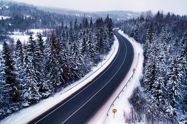 Camino de invierno en la vista de drones de las montañas